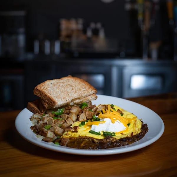 Driftwood Cafe's breakfast plate with an omelet, home fries, and toast on a white plate.